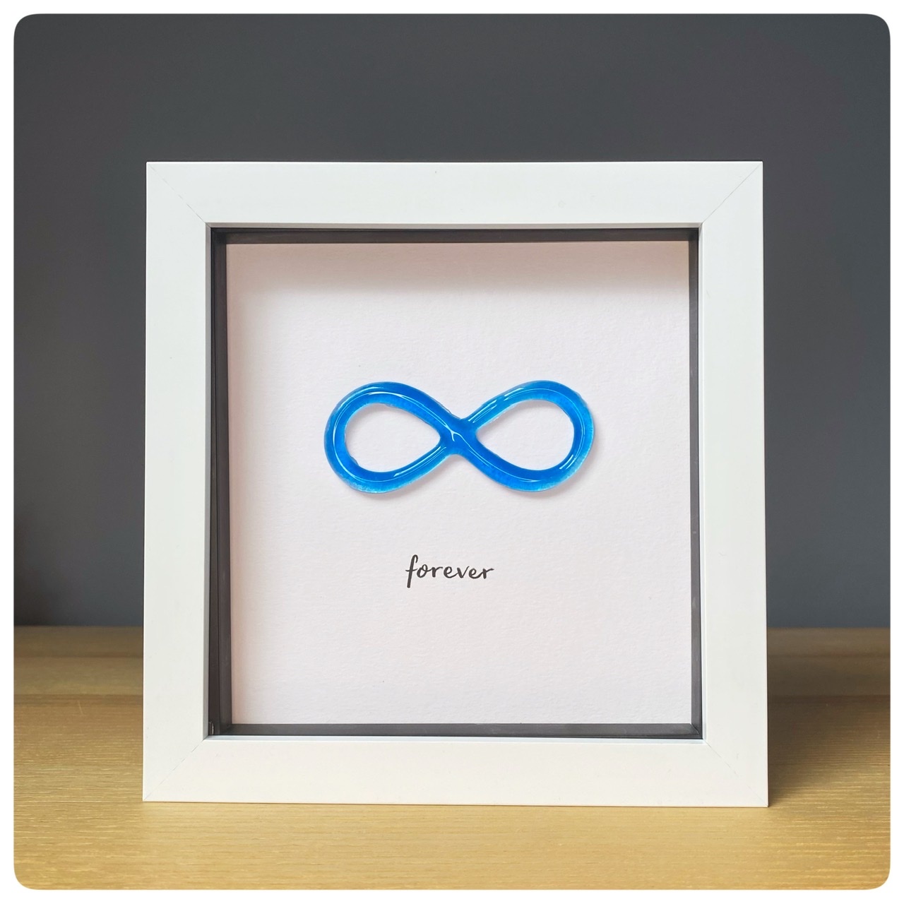 Forever blue glass infinity symbol in frame